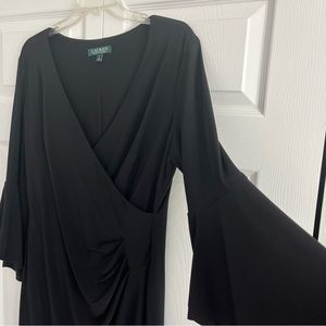 Elegant black Lauren dress with flutter sleeve and mock wrap.